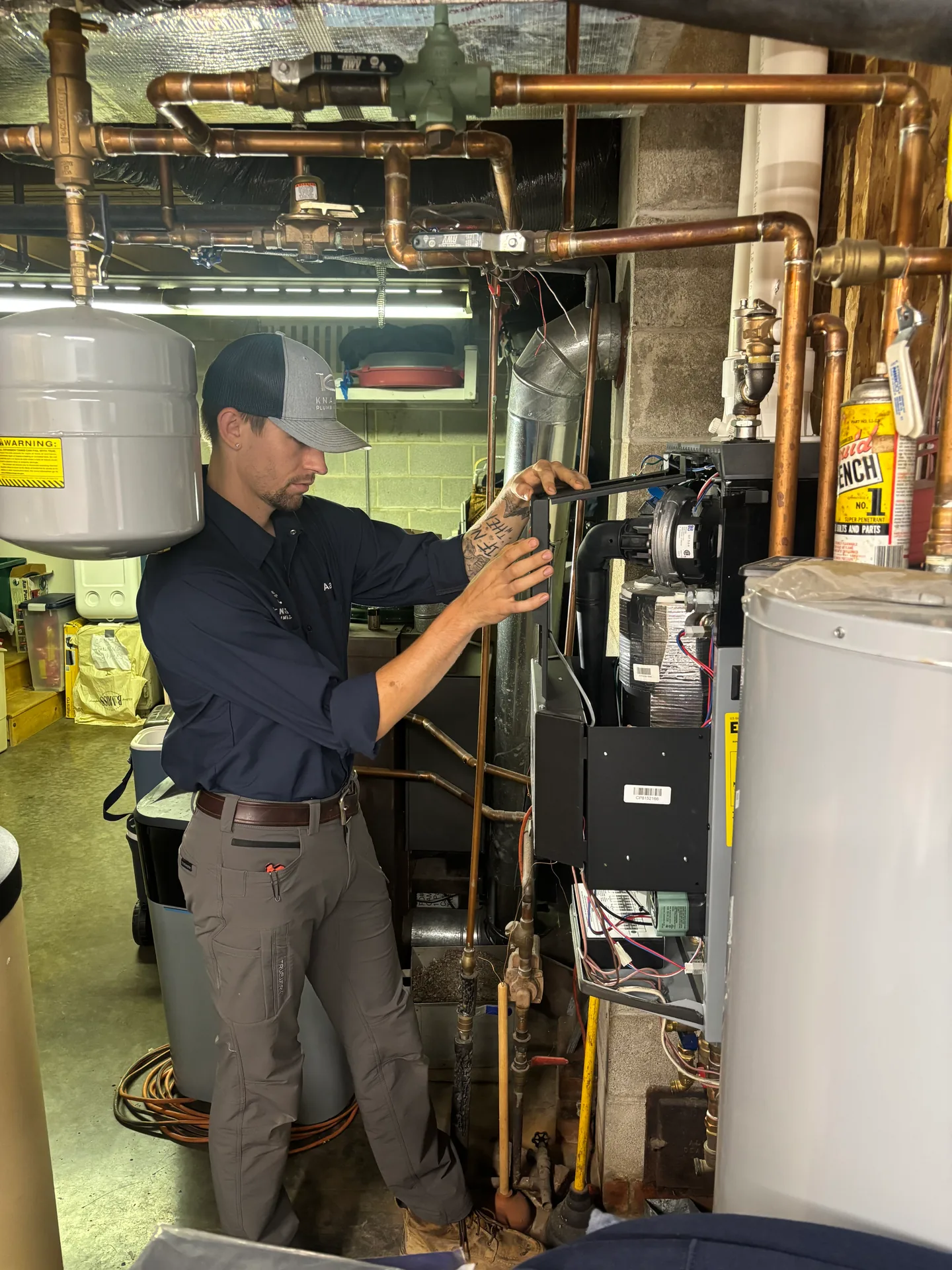 Boiler Circulator Service by Knauss Plumbing Knauss Plumbing owner servicing boiler circulator piping in a basement mechanical room.