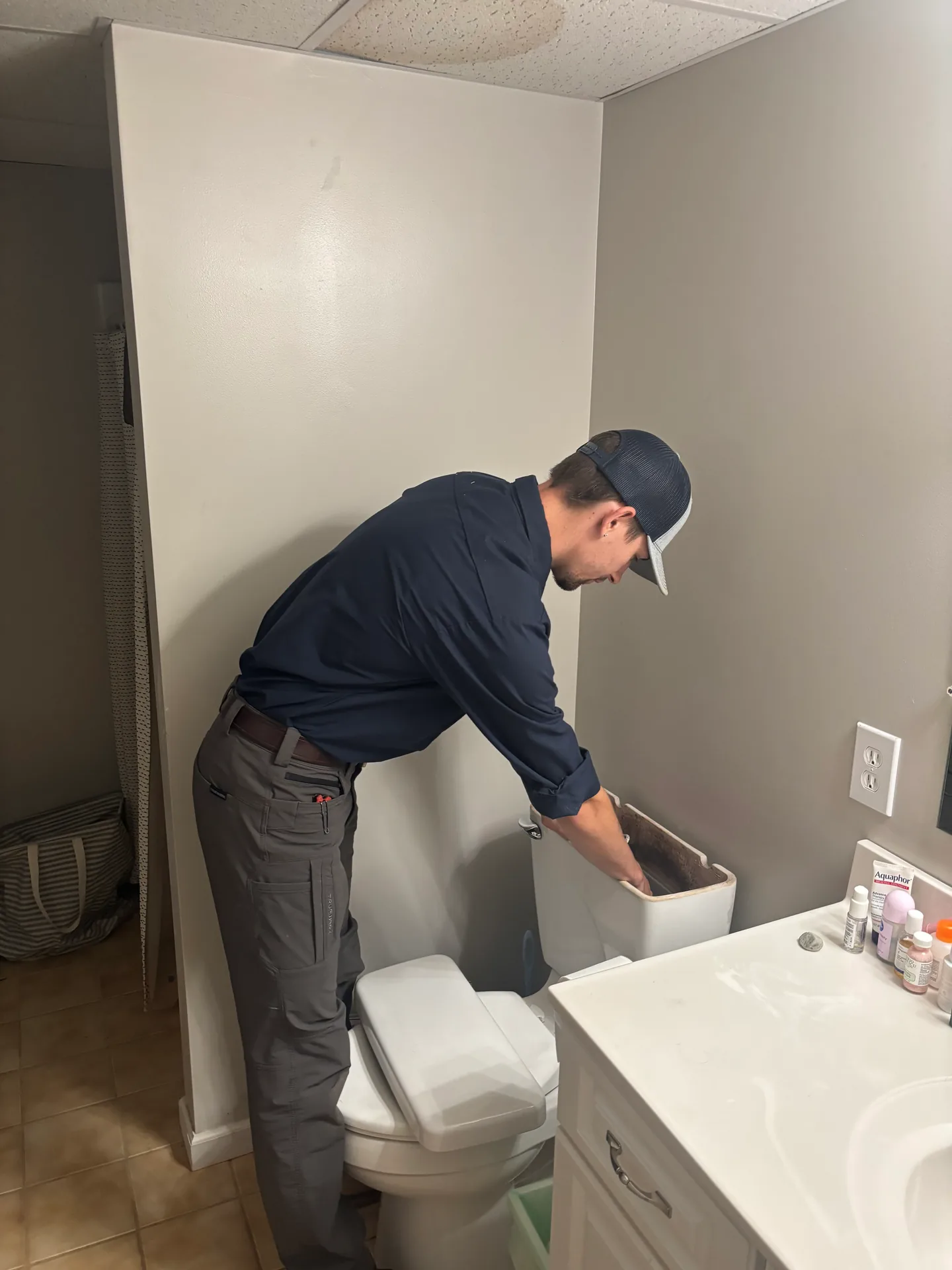 Toilet Installation Prep by Knauss Plumbing Knauss Plumbing owner preparing a bathroom toilet area during a repair or installation.