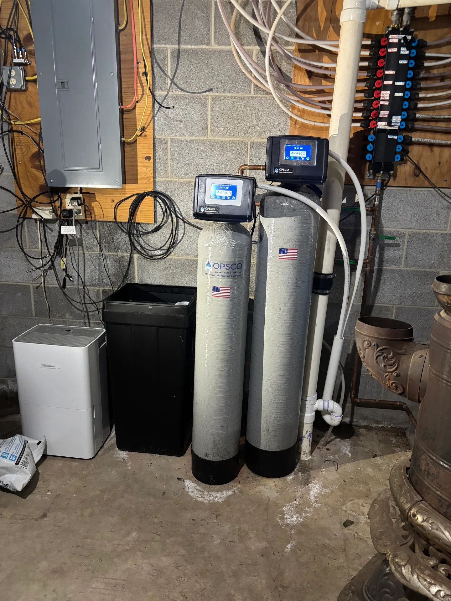 Water Treatment Equipment Installation Installed residential water treatment and filtration equipment in a basement utility area.