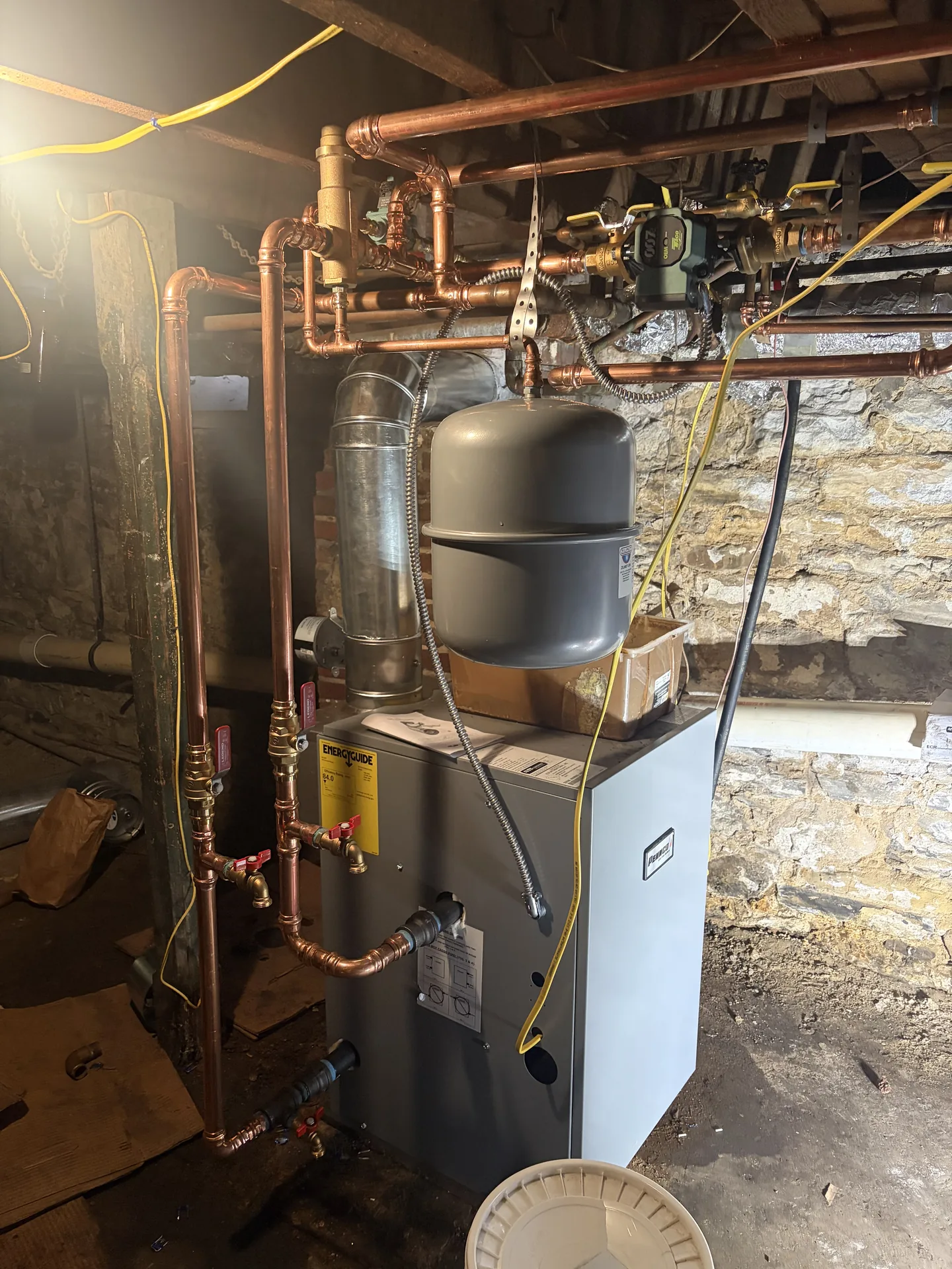 Mechanical room equipment and piping connected cleanly near gas and boiler systems.